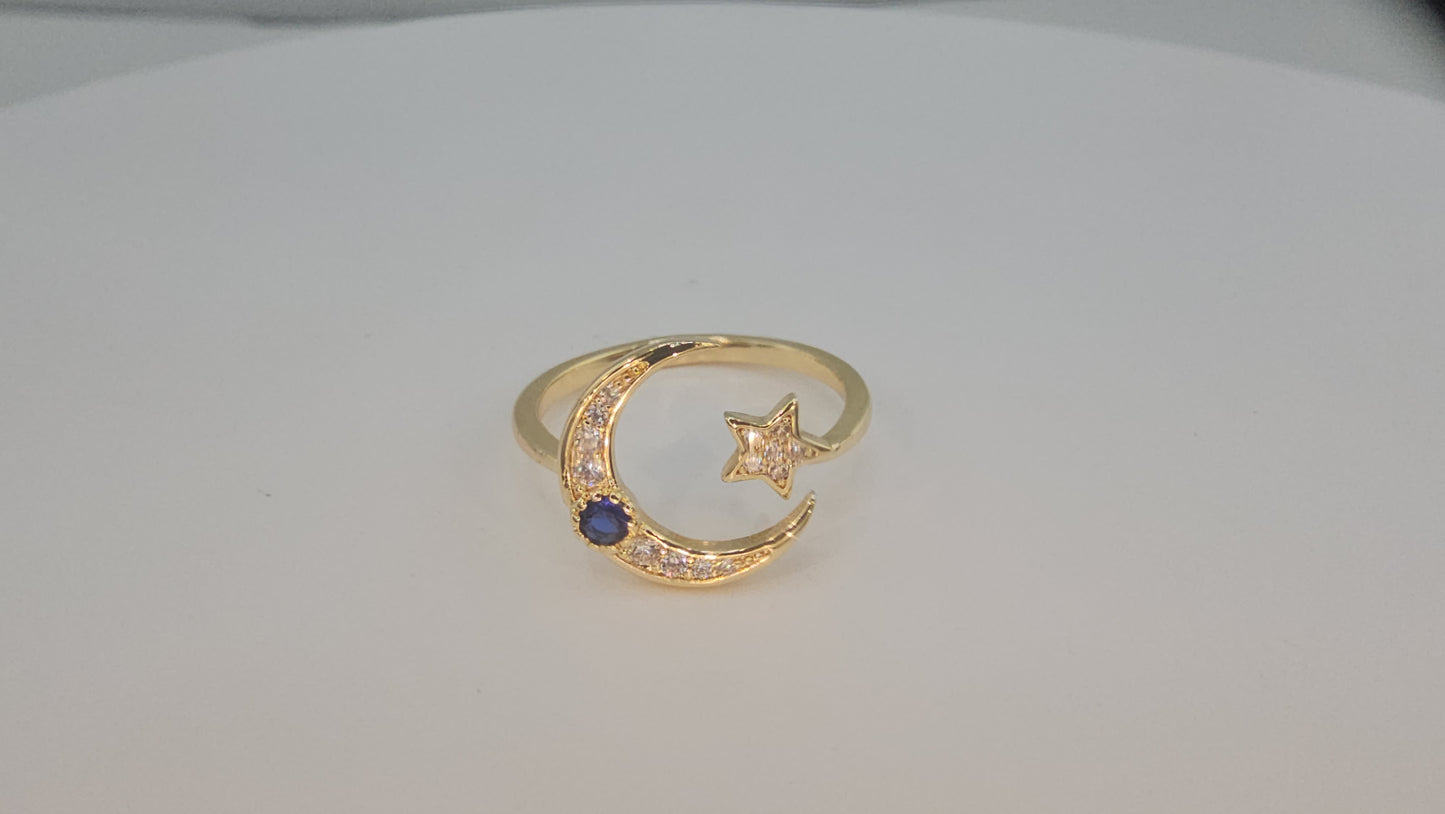 Dainty Crescent moon and star w/ blue stone. Item# Q485 $18.00